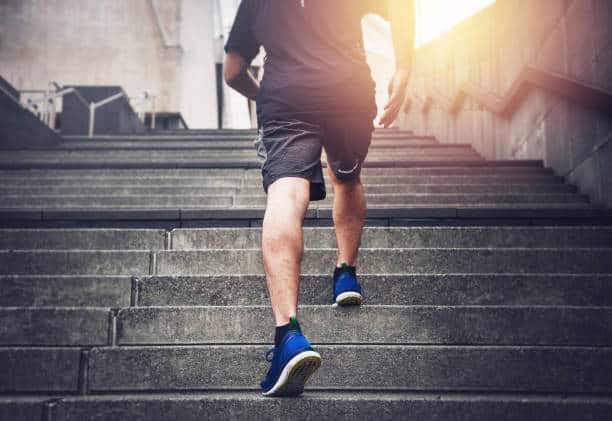 Close Up Of Young Man Running Up The Stairs With Running Clothes