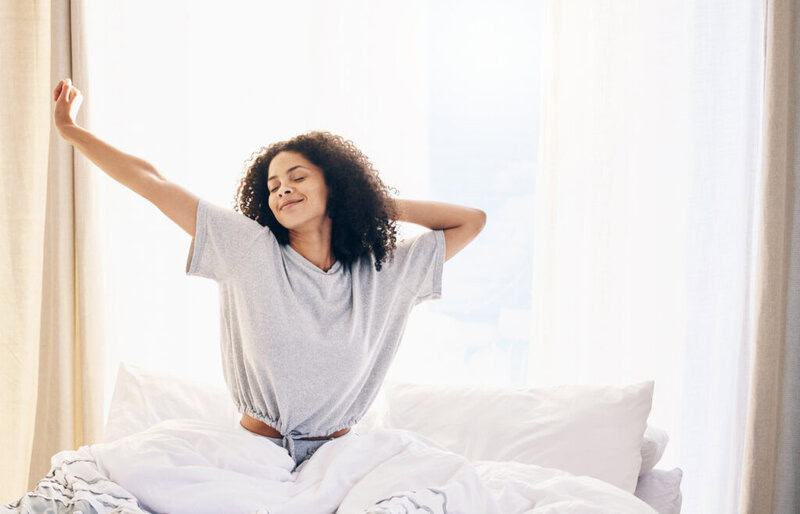 Black Woman, Morning Stretching And Waking Up In Home Bedroom After Sleeping Or Resting. Relax, Peace And Comfort Of Happy Female Stretch After Sleep Feeling Fresh, Awake And Well Rested In House.