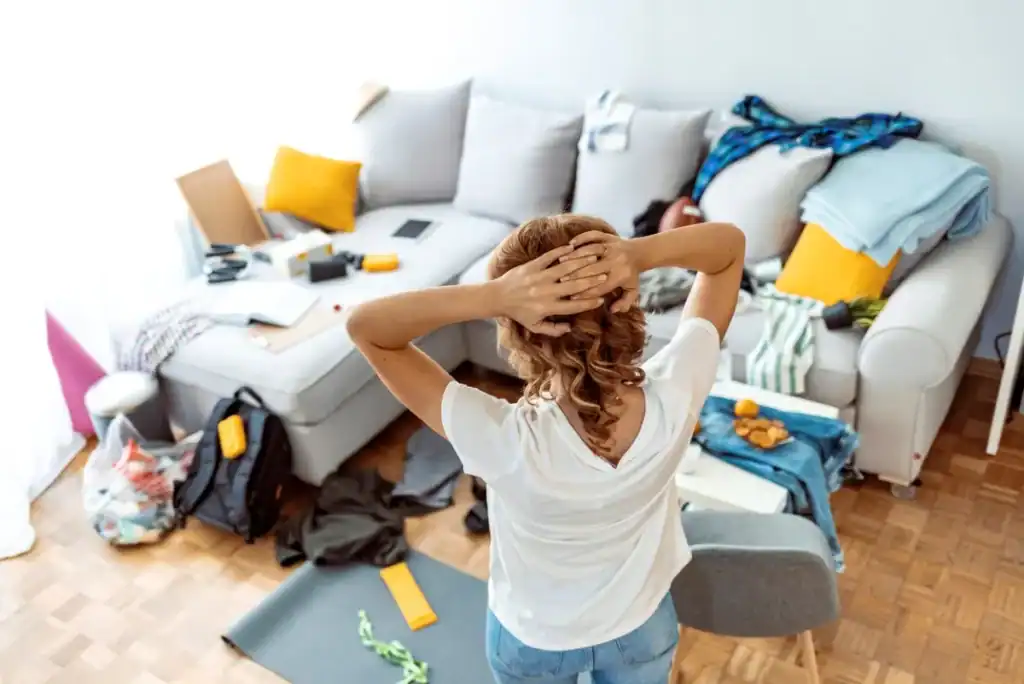 Istock 1348239252 How To Declutter Your Home Woman Looking At Clutter Room